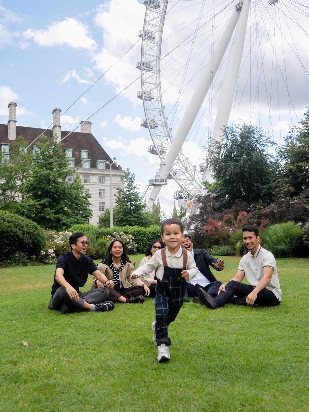Family photographed outdoors near the London Eye
