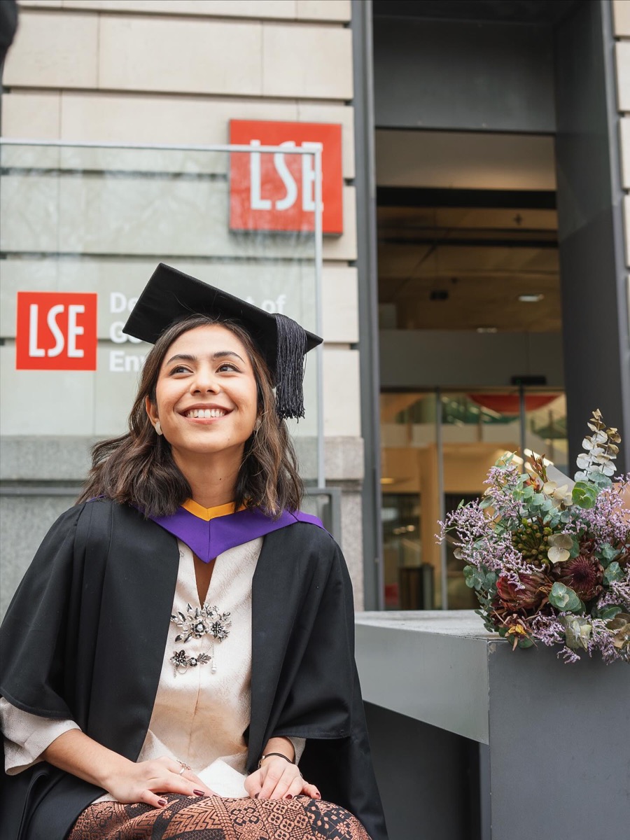 LSE graduate wearing academic dress outside the university